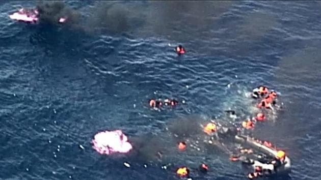 Image grab from video footage showing migrants jumping from a black pneumatic boat that suddenly caught fire off the Spanish coast on Sunday. (AFP Photo)