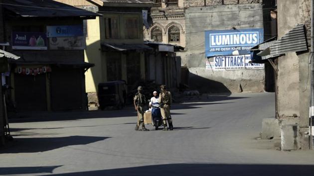 Soldiers question a man on a motorcycle at a temporary checkpoint during restrictions in Srinagar on Monday. (Mukhtar Khan/AP photo) Soldiers question a man on a motorcycle at a temporary checkpoint during restrictions in Srinagar on Monday. (Mukhtar Khan/AP photo)
