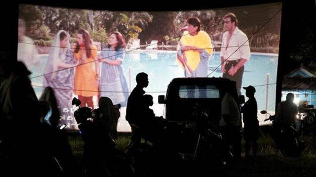 People watch a film during a wedding party in Bogor. He transports a 35-mm projector and sound system, films, a screen and large tent in his truck. (REUTERS)