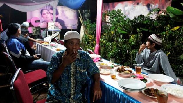 The movies usually run into the early hours of the morning, with street vendors selling food, clothes and toys often setting up nearby, to sell their wares to the cinema-goers. (REUTERS)