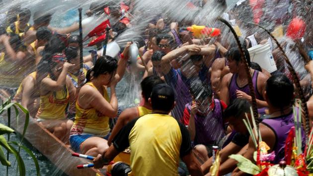 Participants splash water during a ceremony in between races during Tung Ng or Dragon Boat Festival. (Bobby Yip / REUTERS)