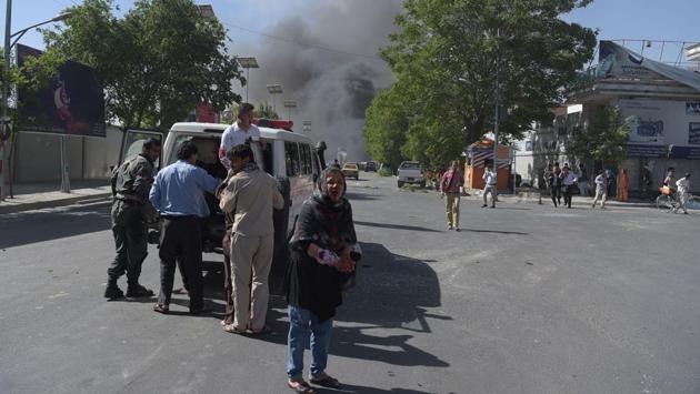 A wounded Afghan woman (C) looks on after receiving first aid at the site of a car bomb attack in Kabul . (SHAH MARAI / AFP)