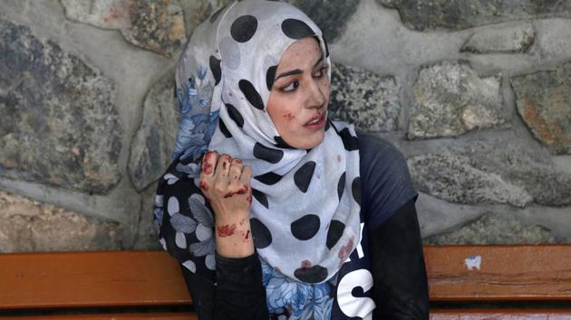 A woman sits outside a hospital after a blast in Kabul, Afghanistan. (Mohammad Ismail / REUTERS)