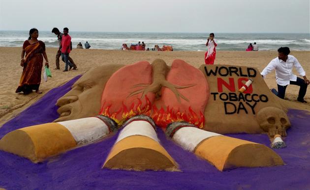 Sand artist Manas Sahoo creates a sand sculpture on eve of 'World No Tobacco Day', in Puri, on Tuesday. (PTI) Sand artist Manas Sahoo creates a sand sculpture on eve of 'World No Tobacco Day', in Puri, on Tuesday. (PTI)