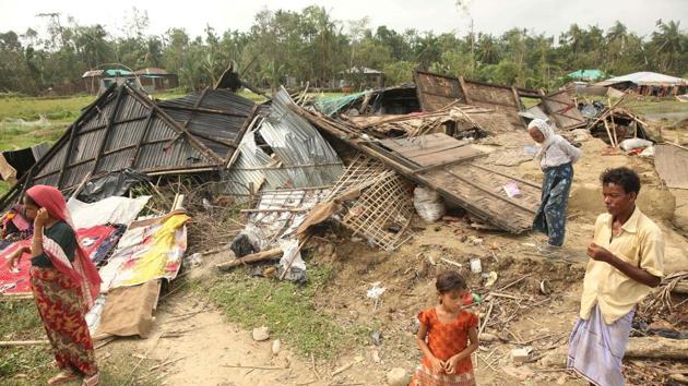 Bangladeshi villagers are seen standing next to a house destroyed by the cyclone. (Munir UZ Zaman/AFP) Bangladeshi villagers are seen standing next to a house destroyed by the cyclone. (Munir UZ Zaman/AFP)