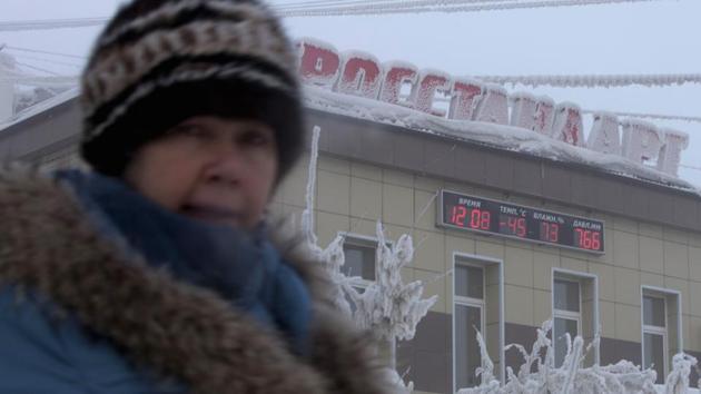 A woman passes a board on a building, displaying the local time, temperature, humidity and air pressure in Yakutsk. (Maxim Shemetov / REUTERS) A woman passes a board on a building, displaying the local time, temperature, humidity and air pressure in Yakutsk. (Maxim Shemetov / REUTERS)