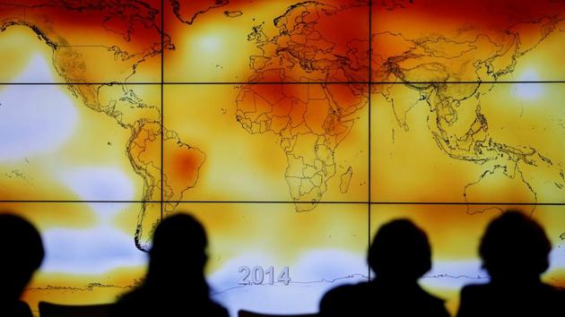 File photo of participants looking at a screen showing a world map with climate anomalies during the World Climate Change Conference 2015 (COP21) at Le Bourget, near Paris, France.(Reuters)