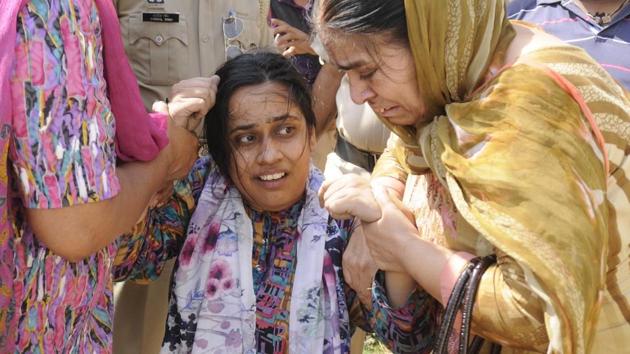 The grieving kin of Rajatvir Singh who, the police claimed, had killed himself as cops raided his house to probe terror links, in Patiala on Thursday, June 1. (Bharat Bhushan/HT) The grieving kin of Rajatvir Singh who, the police claimed, had killed himself as cops raided his house to probe terror links, in Patiala on Thursday, June 1. (Bharat Bhushan/HT)