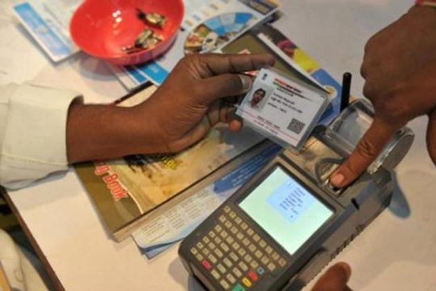 An Indian visitor gives a thumb impression to withdraw money from his bank account with his Aadhaar or Unique Identification (UID) card during a Digi Dhan Mela.(AFP Photo)