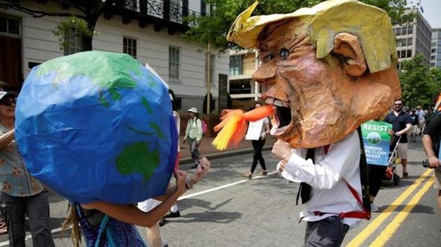 Protesters dressed as the earth and US president Donald Trump pretend to fight during the Peoples Climate March near the White House in Washington on April 29. (Reuters file photo) Protesters dressed as the earth and US president Donald Trump pretend to fight during the Peoples Climate March near the White House in Washington on April 29. (Reuters file photo)