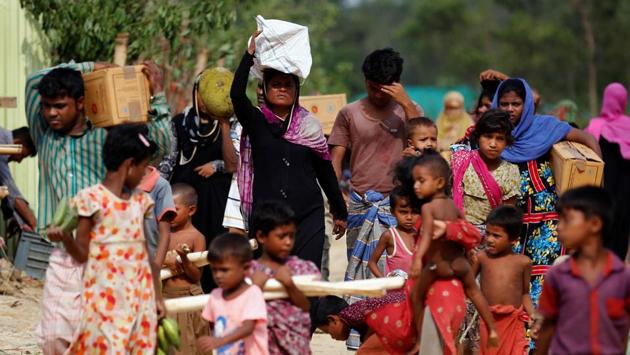 Refugees make their way back to their makeshift home after collecting relief supplies. (Mohammad Ponir Hossain/REUTERS) Refugees make their way back to their makeshift home after collecting relief supplies. (Mohammad Ponir Hossain/REUTERS)