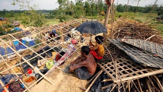 Rohingya refugees sit in front of their house destroyed by Cyclone Mora at the Balukhali Makeshift Refugee Camp in Cox’s Bazar, Bangladesh. Left drenched and near destitute by a cyclone that hit Bangladesh few days ago, thousands of Rohingya refugees hunkered down in the ruins of their camps , waiting for help after a night in the rain. According to administrative officials at least seven people were killed and 50 injured by Cyclone Mora, affecting over a quarter million people in the country. (Mohammad Ponir Hossain/REUTERS) Rohingya refugees sit in front of their house destroyed by Cyclone Mora at the Balukhali Makeshift Refugee Camp in Cox’s Bazar, Bangladesh. Left drenched and near destitute by a cyclone that hit Bangladesh few days ago, thousands of Rohingya refugees hunkered down in the ruins of their camps , waiting for help after a night in the rain. According to administrative officials at least seven people were killed and 50 injured by Cyclone Mora, affecting over a quarter million people in the country. (Mohammad Ponir Hossain/REUTERS)