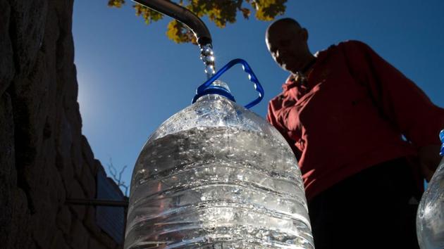 A man collects drinking water from taps that are fed by a spring in Newlands on May 15, 2017, in Cape Town. South Africa's Western Cape region which includes Cape Town declared a drought disaster on May 22 as the province battled its worst water shortages for 113 years. (AFP) A man collects drinking water from taps that are fed by a spring in Newlands on May 15, 2017, in Cape Town. South Africa's Western Cape region which includes Cape Town declared a drought disaster on May 22 as the province battled its worst water shortages for 113 years. (AFP)