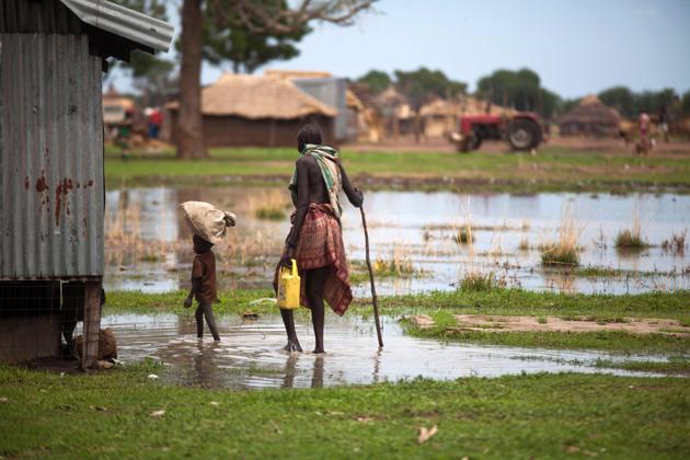 A woman with a boy walk in a flooded area in Panthau. More than 1.8 million people who fled their homes have left South Sudan altogether, sparking what has become the world’s fastest-growing refugee crisis. (Albert Gonzalez Farran / AFP) 