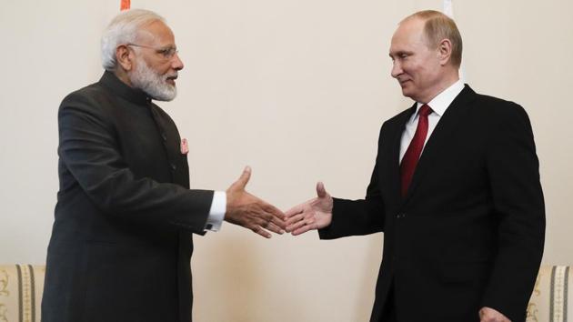 Indian Prime Minister Narendra Modi shakes hands with Russian President Vladimir Putin before their talks at the St Petersburg International Economic Forum in Russia.(AP Photo)