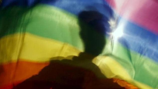 A gay man is silhouetted on a gay rainbow flag during a demonstration for gay rights in Hanoi, Vietnam, in November 2015. (Reuters) A gay man is silhouetted on a gay rainbow flag during a demonstration for gay rights in Hanoi, Vietnam, in November 2015. (Reuters)