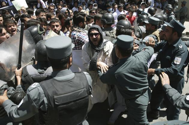 Police forces clash with protesters during a demonstration in Kabul on Friday.(AP)