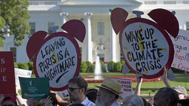 Protesters gather outside the White House in Washington, Thursday, June 1, 2017, to protest President Donald Trump's decision to withdraw the Unites States from the Paris climate change accord. (AP Photo) Protesters gather outside the White House in Washington, Thursday, June 1, 2017, to protest President Donald Trump's decision to withdraw the Unites States from the Paris climate change accord. (AP Photo)