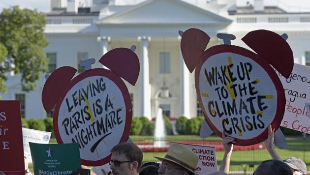 Protesters gather outside the White House in Washington, to protest President Donald Trump's decision to withdraw the Unites States from the Paris climate change accord. (AP Photo) Protesters gather outside the White House in Washington, to protest President Donald Trump's decision to withdraw the Unites States from the Paris climate change accord. (AP Photo)