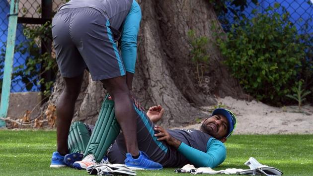 Pakistan's Sarfraz Ahmed (R) gets attention on the floor during a nets practice session. (AFP) Pakistan's Sarfraz Ahmed (R) gets attention on the floor during a nets practice session. (AFP)