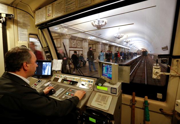A Moscow metro employee drives a train through a metro station. The Moscow metro’s immaculate stations are a mix of old and new. (REUTERS) A Moscow metro employee drives a train through a metro station. The Moscow metro’s immaculate stations are a mix of old and new. (REUTERS)
