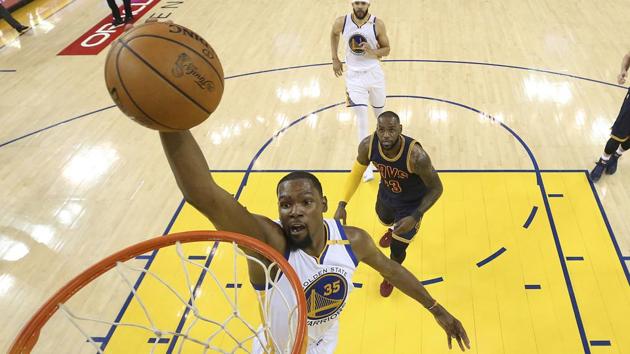 Golden State Warriors forward Kevin Durant dunks in front of Cleveland Cavaliers forward LeBron James during the NBA Finals.(AP)