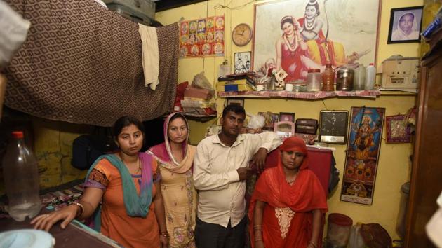 E-rickshaw driver Ravinder Kumar’s family at their house in JJ Cluster slum colony, GTB Nagar, on Friday.(Sonu Mehta/HT PHOTO)