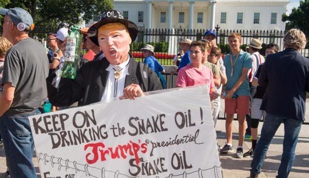 A protester holds up sign during a demonstration in front of the White House in Washington, DC, objecting to US President Donald Trump's decision to withdraw from the Paris Climate accord. (AFP) A protester holds up sign during a demonstration in front of the White House in Washington, DC, objecting to US President Donald Trump's decision to withdraw from the Paris Climate accord. (AFP)