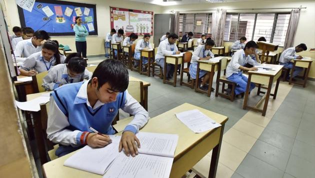 Students of class 12 attending exam during the first day of the CBSE exam at a centre.(Sanjeev Verma/ Hindustan Times)
