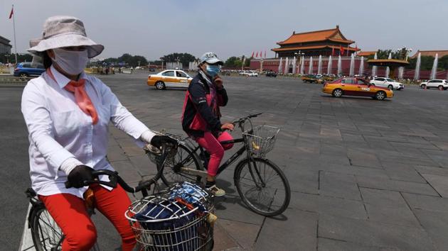 Cyclists ride past Tiananmen Gate on June 3, 2017, the eve of the 28th anniversary of the June 4, 1989 crackdown on pro-democracy protests in Beijing. The Tiananmen pro-democracy movement ended in bloodshed when tanks crushed the demonstrations, killing hundreds of protesters.(AFP)