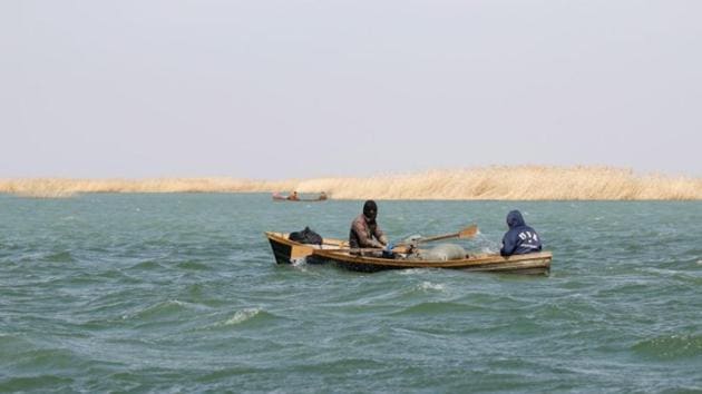 Fishermen sail a boat on the Aral Sea outside the village of Karateren. 