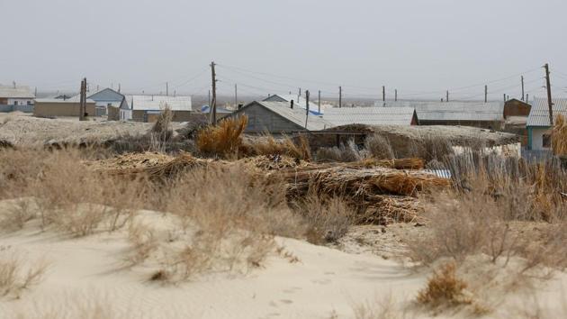 House are surrounded by dunes in the village of Karateren. The Aral was nearly destroyed as a result of the Soviet Union’s plan to boost cotton production by diverting Syr Darya and Amu Darya, the two rivers feeding it, to irrigate the desert. (Shamil Zhumatov / REUTERS) 