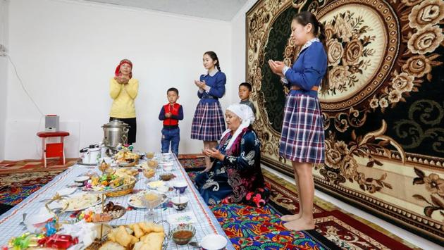 Boldai Zhaksylykova (2nd R) and her family members pray after dinner at home in the village of Bogen. (Shamil Zhumatov / REUTERS) 