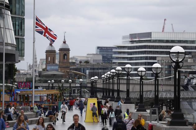 People walk along the banks of the River Thames near Tower Bridge with a Union flag flying at half-mast outside City Hall in London following the deady terror attack. (AFP Photo) People walk along the banks of the River Thames near Tower Bridge with a Union flag flying at half-mast outside City Hall in London following the deady terror attack. (AFP Photo)