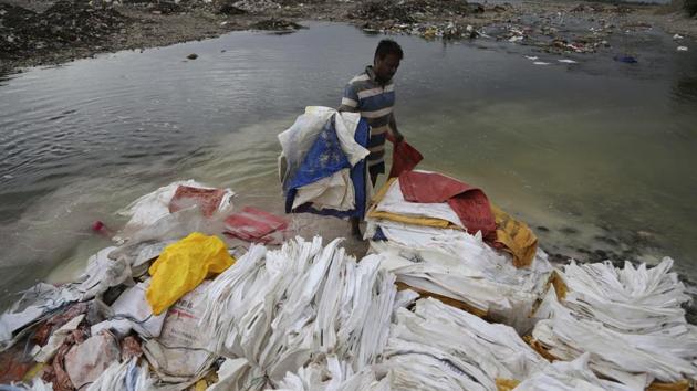 A man washes sacks used to carry limewash in a shallow on the banks of river Tawi in Jammu. In many households, safe drinking water is not a basic amenity rather a luxury especially in semi-urban and rural areas. According to a report ,each day approximately 500 million litres of wastewater from industrial sources is dumped into the rivers of India. (Channi Anand / AP)