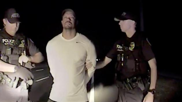 Tiger Woods is seen handcuffed and searched by police officers in this still image from police dashcam video in Jupiter, Florida, U.S. (REUTERS) Tiger Woods is seen handcuffed and searched by police officers in this still image from police dashcam video in Jupiter, Florida, U.S. (REUTERS)