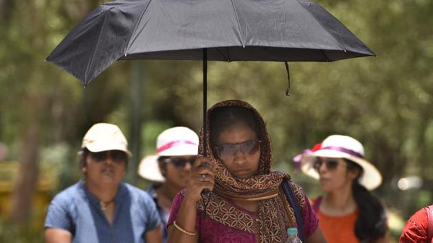 People wear protective gears to beat the heat near Raj Ghat in New Delhi on Sunday. (Sushil Kumar/HT PHOTO) People wear protective gears to beat the heat near Raj Ghat in New Delhi on Sunday. (Sushil Kumar/HT PHOTO)
