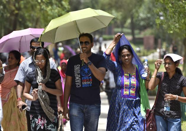 People protect themselves from scorching heat on a hot sunny day near Raj Ghat in New Delhi on Sunday. (Sushil Kumar/HT PHOTO) People protect themselves from scorching heat on a hot sunny day near Raj Ghat in New Delhi on Sunday. (Sushil Kumar/HT PHOTO)