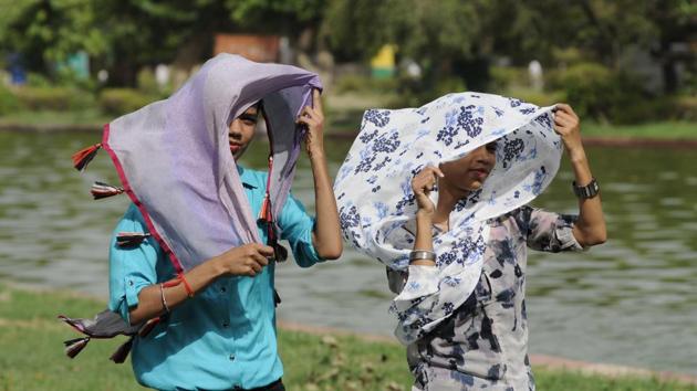 Girls protect themselves with scarfs to avoid the heat on a hot sunny day in New Delhi on Sunday. (Burhaan Kinu/HT PHOTO) Girls protect themselves with scarfs to avoid the heat on a hot sunny day in New Delhi on Sunday. (Burhaan Kinu/HT PHOTO)