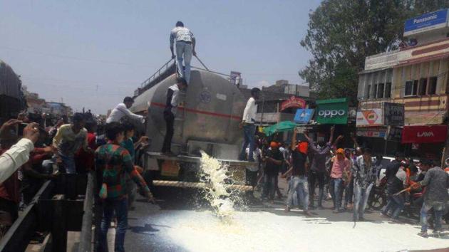 Agitating farmers spilled milk in Dhar district.(Chhotu Shahstri/HT Photo)