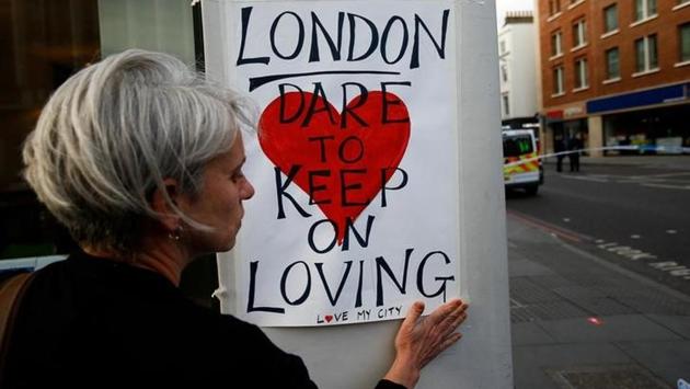 A woman attaches a sign on a street after attackers rammed a hired van into pedestrians on London Bridge and stabbed others nearby killing and injuring people. The attack occurred five days before a parliamentary election and was the third to hit Britain in less than three months.As normal life resumed on Monday after reopening of the bridge, London paid homage to the ones that lost their lives in the terror attack with flowers and slogans of love, strength and unity. (Peter Nicholls/REUTERS) A woman attaches a sign on a street after attackers rammed a hired van into pedestrians on London Bridge and stabbed others nearby killing and injuring people. The attack occurred five days before a parliamentary election and was the third to hit Britain in less than three months.As normal life resumed on Monday after reopening of the bridge, London paid homage to the ones that lost their lives in the terror attack with flowers and slogans of love, strength and unity. (Peter Nicholls/REUTERS)