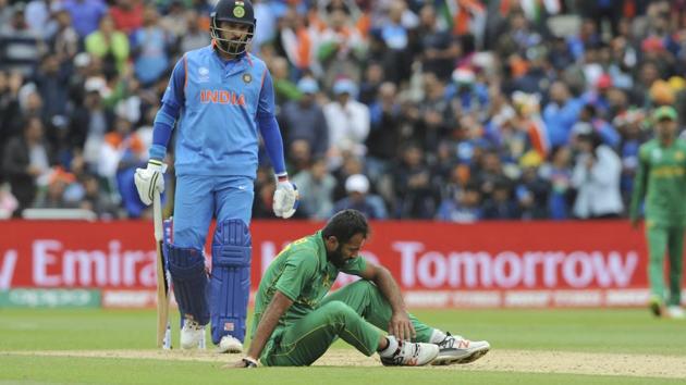 Wahab Riaz sits on the field holding his ankle after an injury during the ICC Champions Trophy 2017 match between India and Pakistan.(AP)