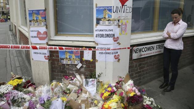 A woman stands next to a flower tribute in London. Police arrested several people and are widening their investigation after a series of attacks described as terrorism killed several people and injured more than 40 others in the heart of London on Saturday. (Tim Ireland/ap) A woman stands next to a flower tribute in London. Police arrested several people and are widening their investigation after a series of attacks described as terrorism killed several people and injured more than 40 others in the heart of London on Saturday. (Tim Ireland/ap)