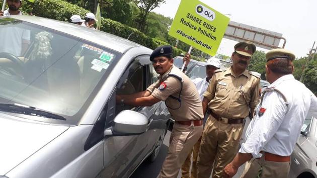 On World Environment Day, the traffic police distributed as many as 350 saplings of holy basil (tulsi) to the commuters at various intersections in Noida. (HT Photo) On World Environment Day, the traffic police distributed as many as 350 saplings of holy basil (tulsi) to the commuters at various intersections in Noida. (HT Photo)