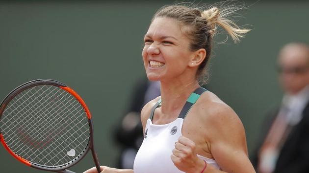 Romania's Simona Halep celebrates winning her fourth round match against Spain's Carla Suarez Navarro at the French Open.(AP)