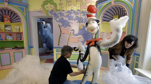 John Simpson (left), project director of exhibitions for The Amazing World of Dr. Seuss Museum, and his wife Kay Simpson, president of Springfield Museums, unwrap a statue of the Cat in the Hat at the museum in Springfield, Massachusetts. (Steven Senne/AP) John Simpson (left), project director of exhibitions for The Amazing World of Dr. Seuss Museum, and his wife Kay Simpson, president of Springfield Museums, unwrap a statue of the Cat in the Hat at the museum in Springfield, Massachusetts. (Steven Senne/AP)