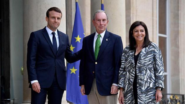 French President Emmanuel Macron (L) and Paris Mayor Anne Hidalgo (R) greet former mayor of New York City Michael Bloomberg (C) in Paris. (Reuters Photo) French President Emmanuel Macron (L) and Paris Mayor Anne Hidalgo (R) greet former mayor of New York City Michael Bloomberg (C) in Paris. (Reuters Photo)