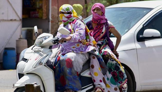 Young girls cover themselves to get protection from scorching sun on a hot day in Bikaner. (PTI) Young girls cover themselves to get protection from scorching sun on a hot day in Bikaner. (PTI)