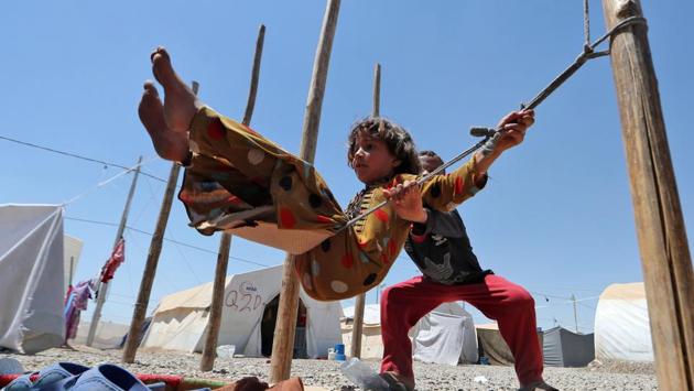 Displaced Iraqi children play on a makeshift swing at al-Khazir camp for the internally displaced, located between Arbil and Mosul. (AFP) Displaced Iraqi children play on a makeshift swing at al-Khazir camp for the internally displaced, located between Arbil and Mosul. (AFP)