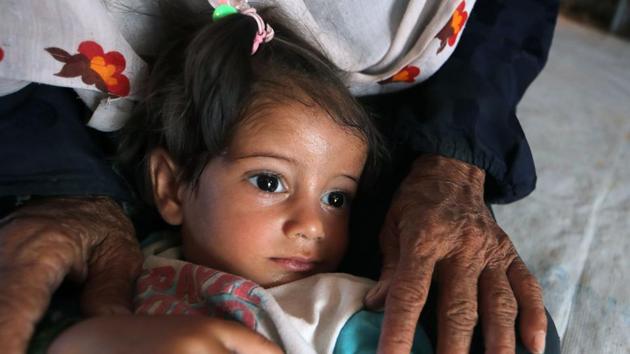 A displaced Iraqi child is comforted by an older woman inside a tent at al-Khazir camp for the internally displaced. (AFP) A displaced Iraqi child is comforted by an older woman inside a tent at al-Khazir camp for the internally displaced. (AFP)